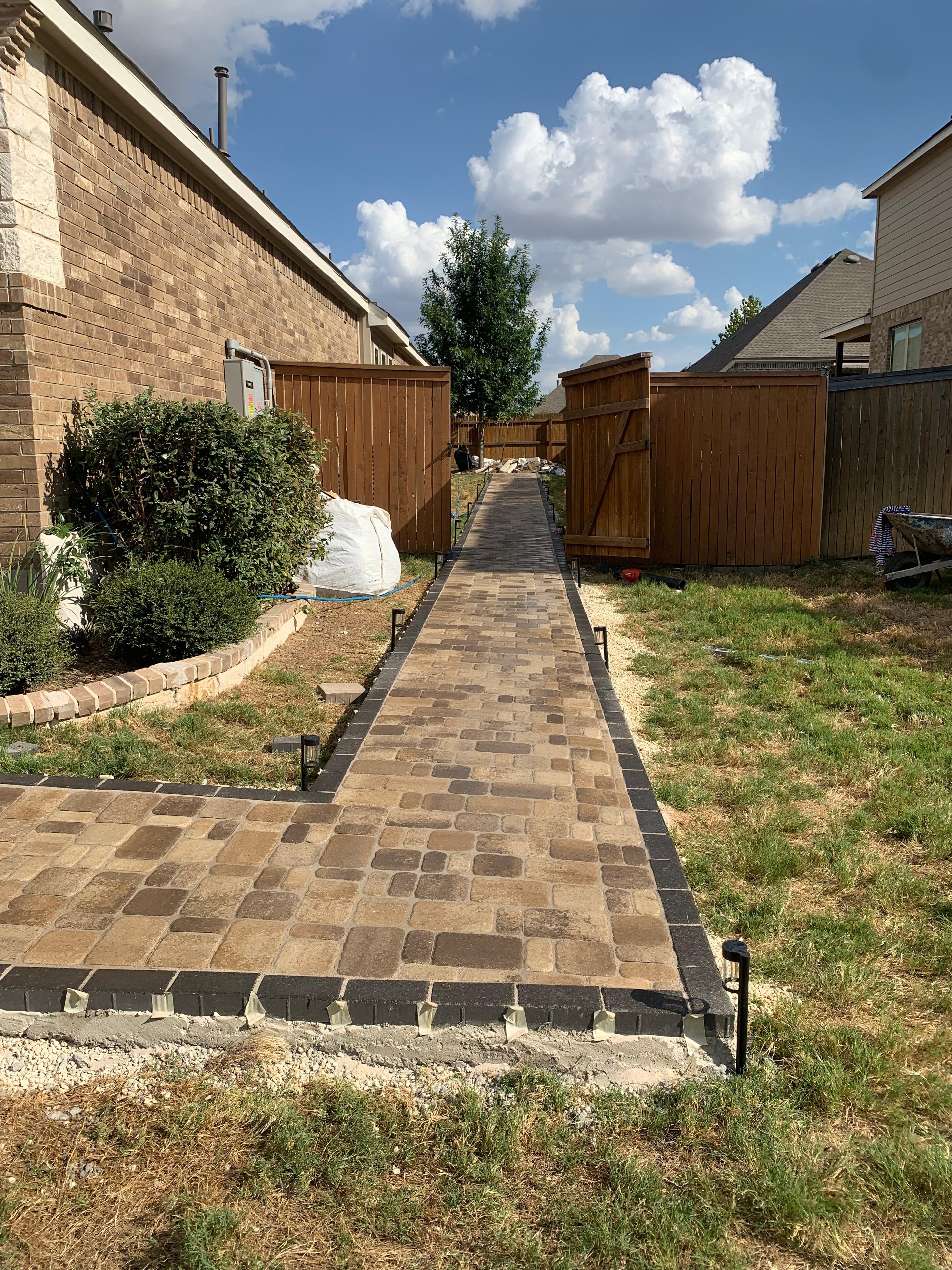 Brick Pathway Between Fences